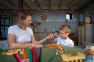 mother-playing-with-her-autistic-son-using-toys
