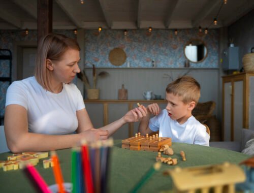 mother-playing-with-her-autistic-son-using-toys