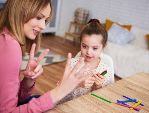 Young mum teaching child to count at home